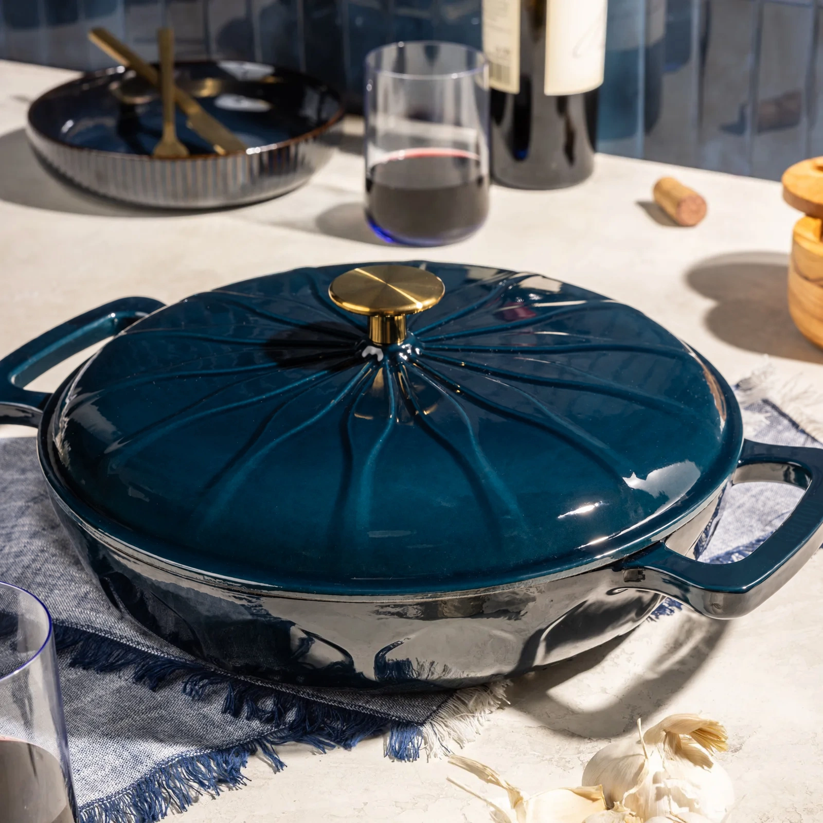 Deep blue enamelled braiser on a kitchen counter